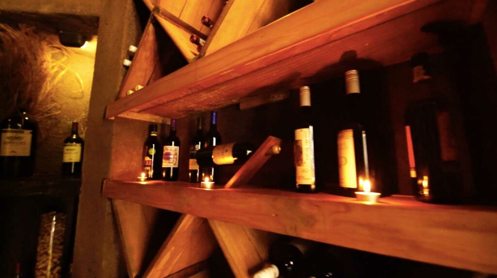 Selection of wine on the wooden wine racks Selection of wine on the wooden wine racks