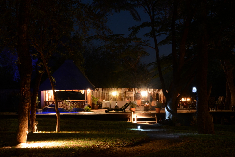 nDzuti by night. The deck, pool area and bar all overlook the waterhole. Photo by Kevin MacLaughlin.
