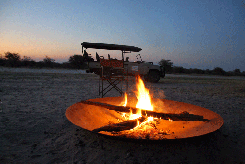 Campfire and a game drive vehicle.