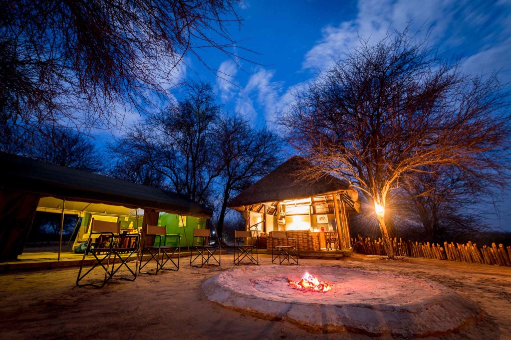 Tuskers main camp area with campfire, dining tent, and thatched bar-lounge