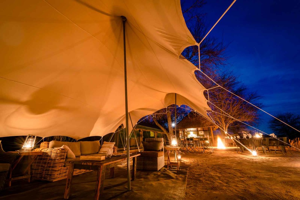 Tented lounge overlooking open plains with a pan