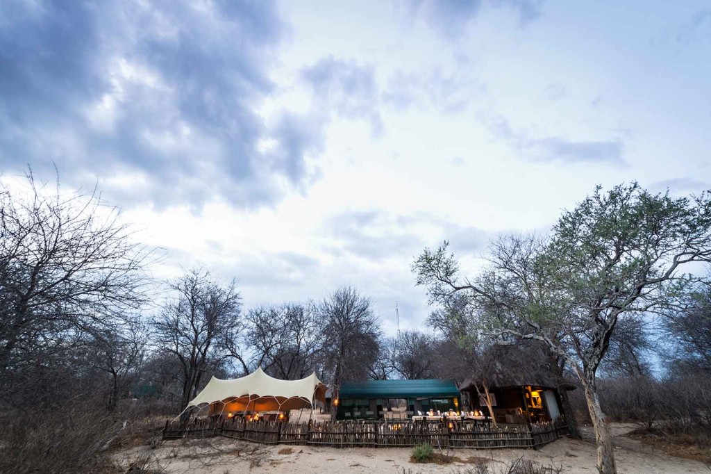 Tuskers Bush Camp main camp area with thatched bar-lounge and tented outdoor lounge area