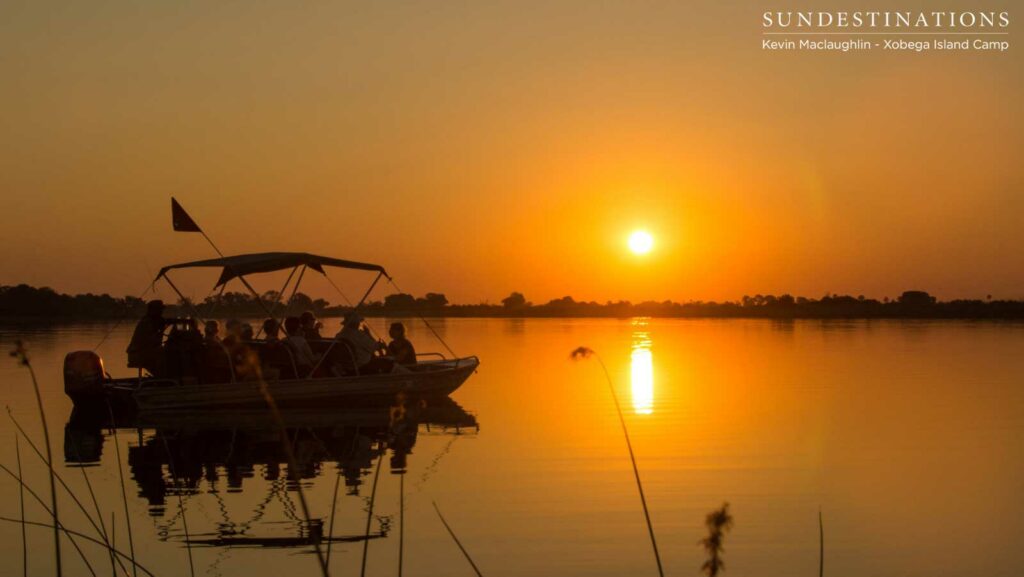 The last burning minutes of the day reflected perfectly in the still waters of the Okavango Delta The last burning minutes of the day reflected perfectly in the still waters of the Okavango Delta